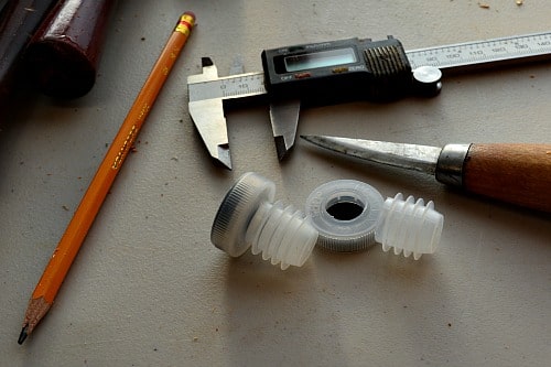 Bottle Stopper: Cutting the top off of the plastic insert.