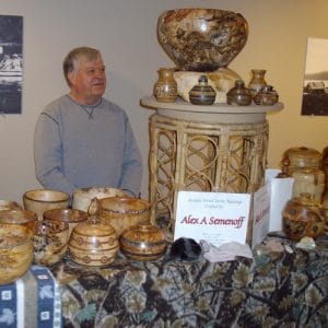 person at booth selling at a craft fair