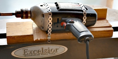 tea light holder, hand drill attached to the wooden sled with strapping