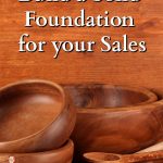 Wooden bowls and spoons in front of a wooden background