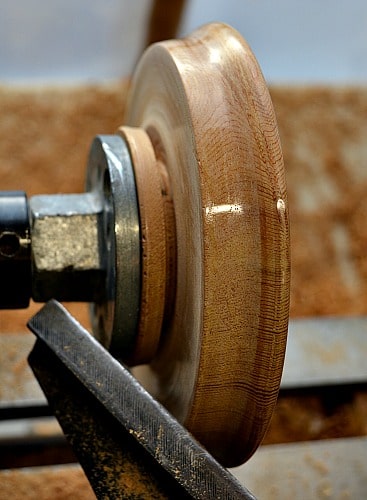 parting the cedar trivet off of the lathe